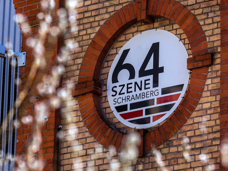 Das Logo der Szene 64 in einer Rotunde des Gebäudes